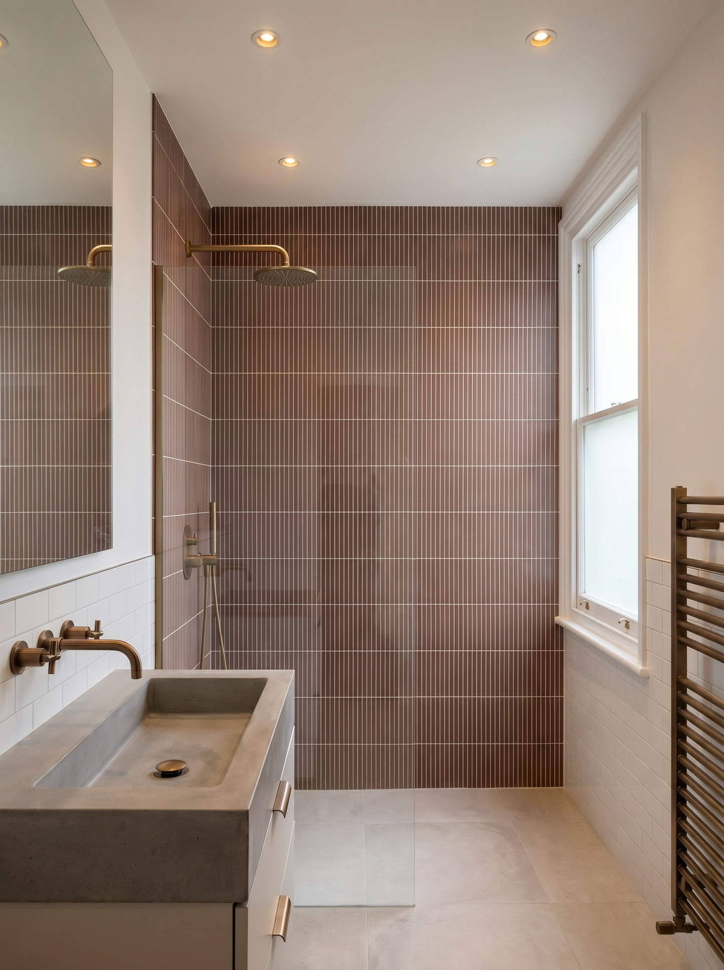 Modern bathroom with tiled walls, a sink, and a window.