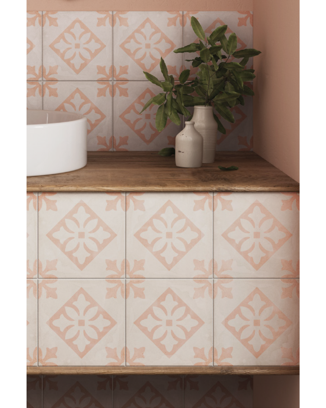 Cabinets with decorative pink tiles and a plant on a wooden surface.